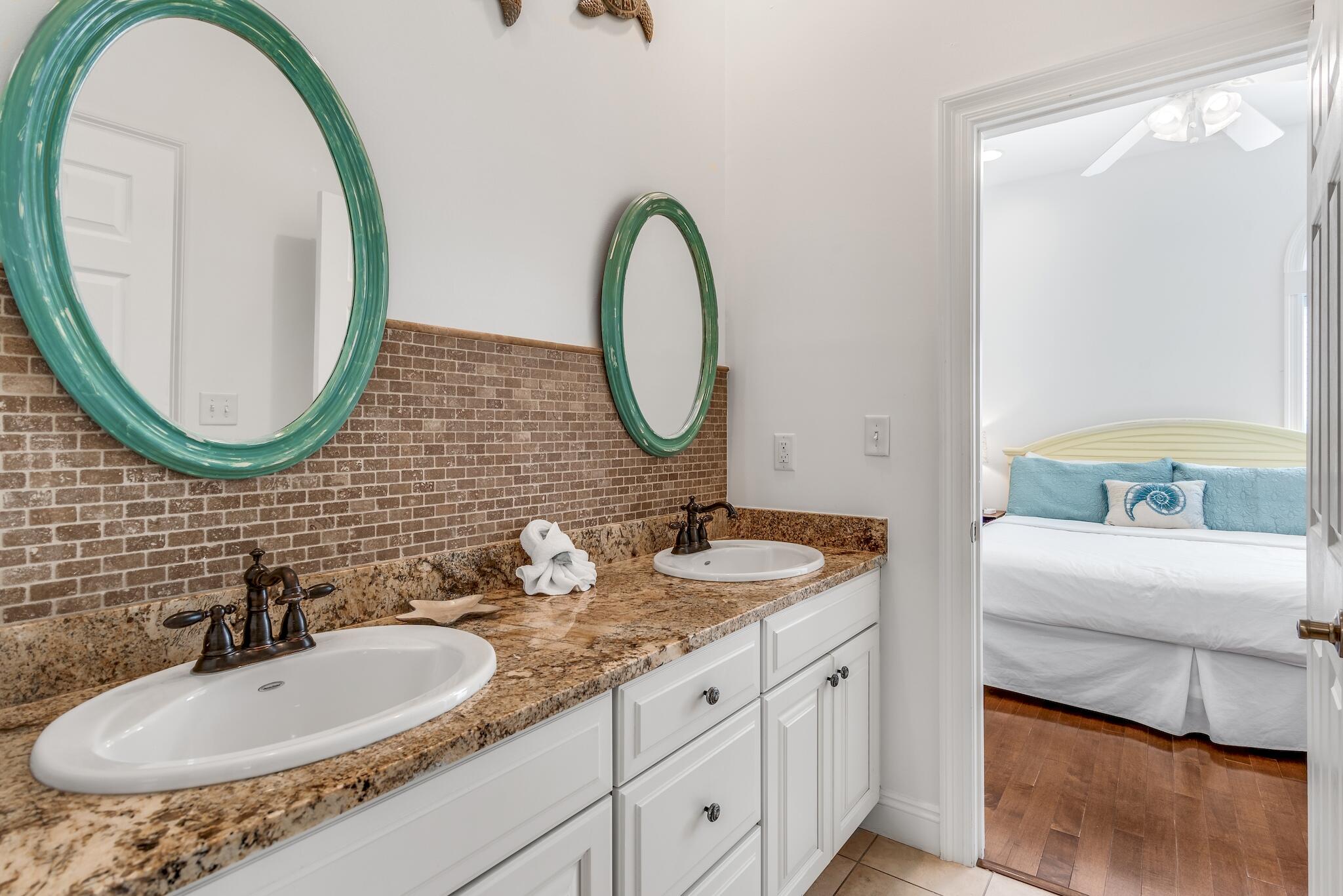 55 The Greenway Loop Panama City Beach, FL 32461 - Photo 24 of 32 a bathroom with 2 sink and a mirror