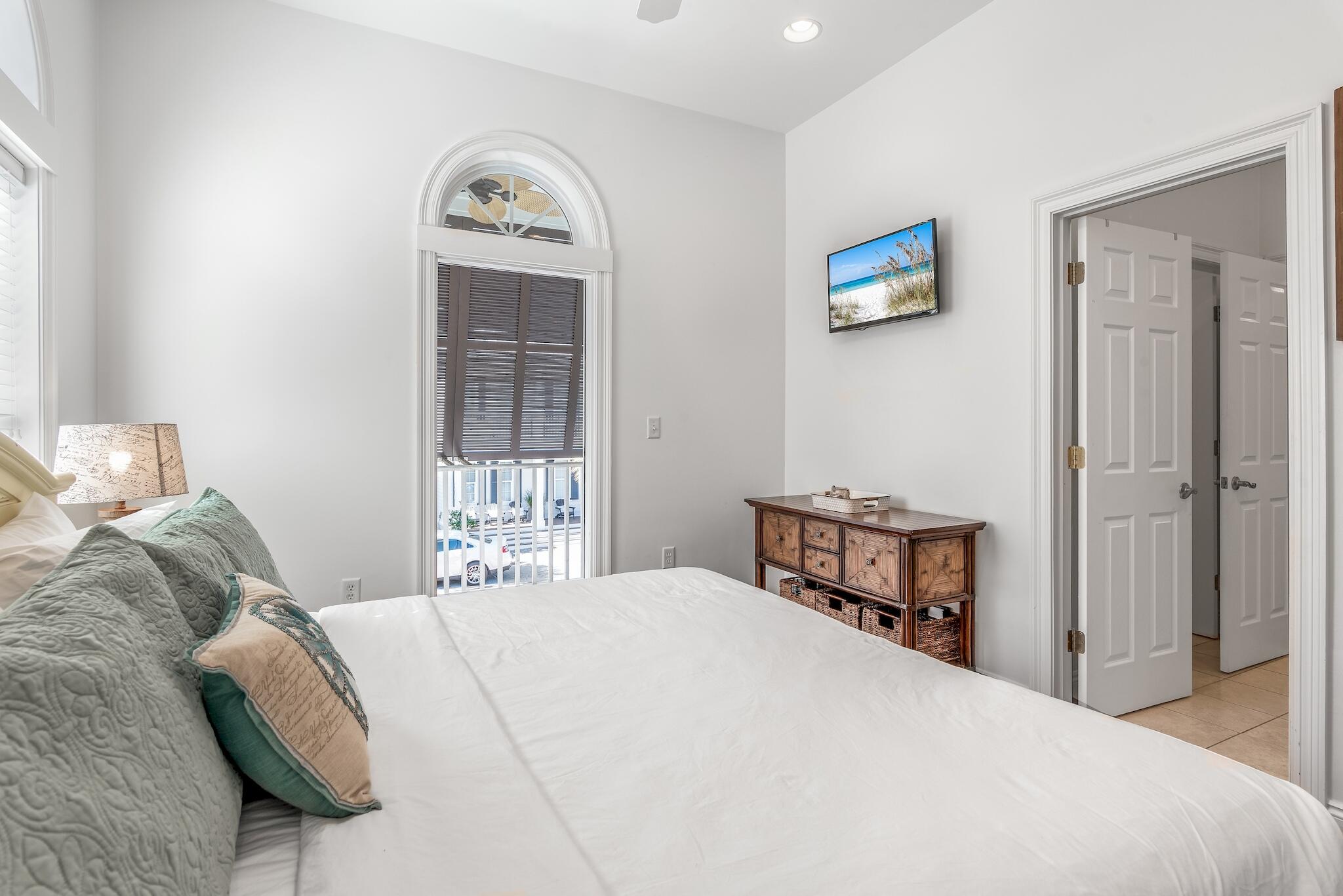 55 The Greenway Loop Panama City Beach, FL 32461 - Photo 28 of 32 a bedroom with a bed and a window