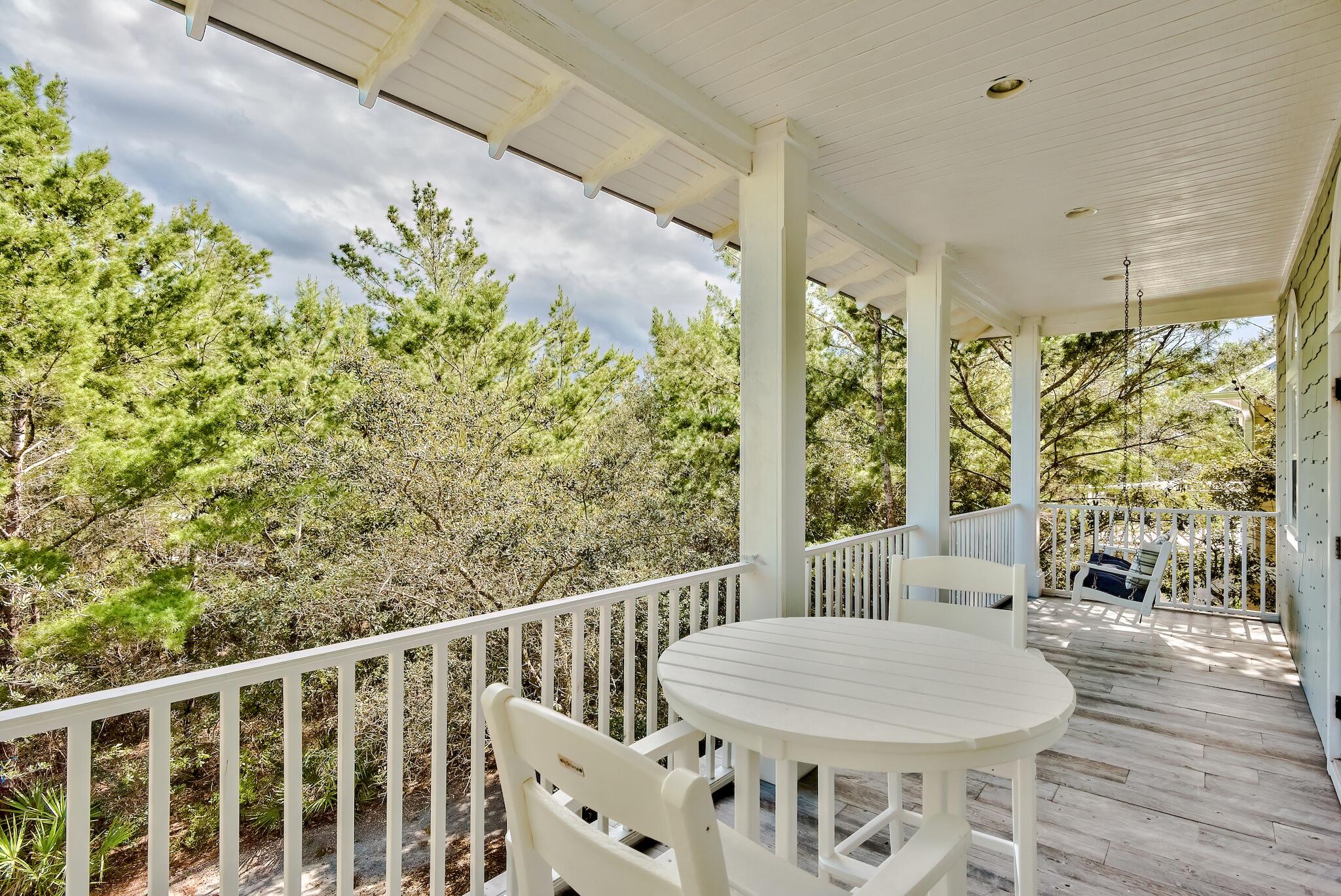 55 The Greenway Loop Panama City Beach, FL 32461 - Photo 29 of 32 a view of a balcony with table and chairs