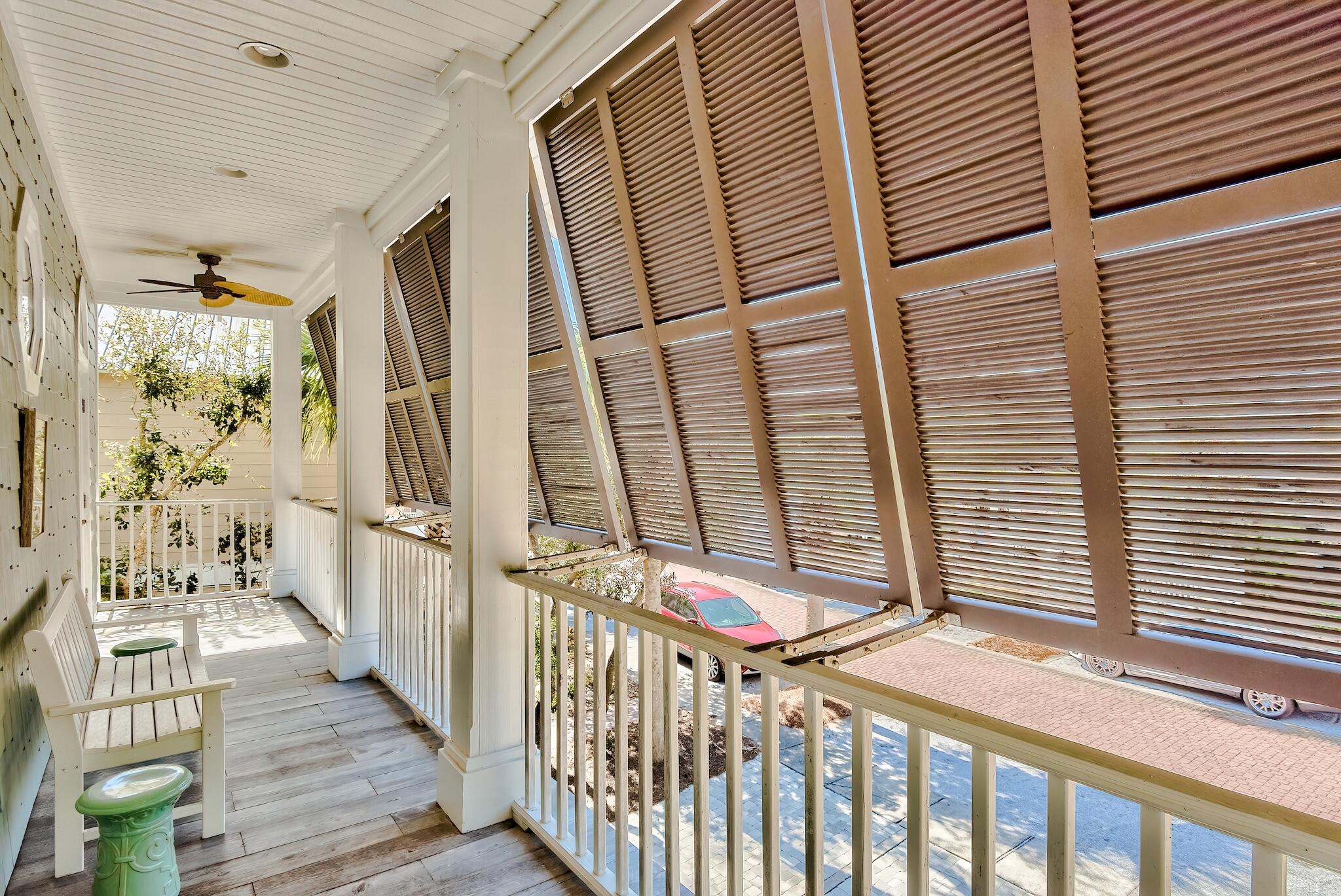 55 The Greenway Loop Panama City Beach, FL 32461 - Photo 30 of 32 a view of a porch with wooden floor