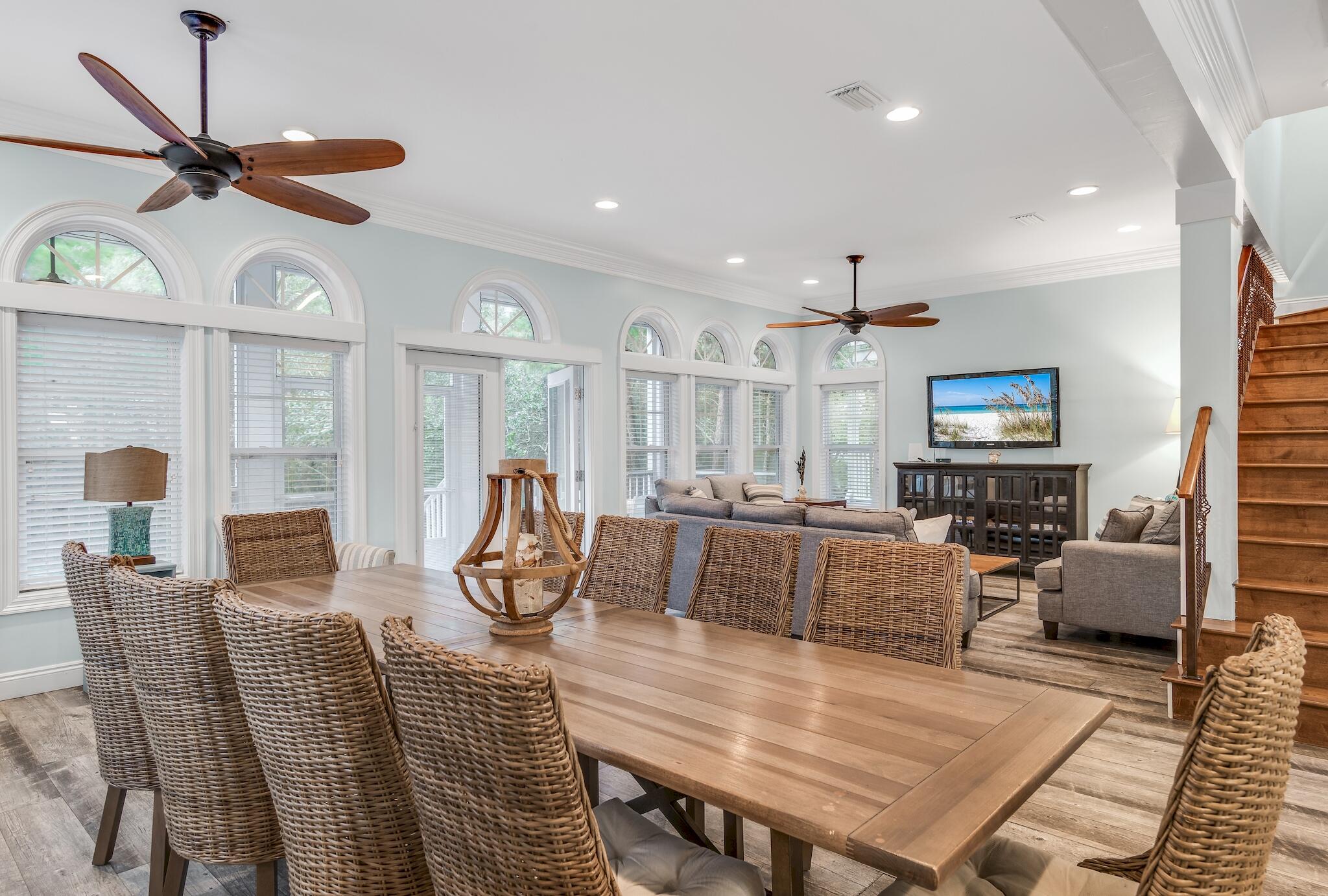 55 The Greenway Loop Panama City Beach, FL 32461 - Photo 3 of 32 a living room with furniture a flat screen tv and kitchen view