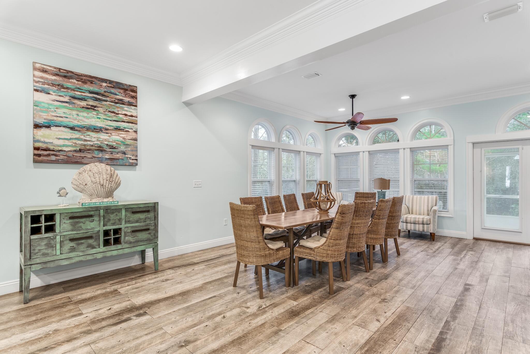 55 The Greenway Loop Panama City Beach, FL 32461 - Photo 7 of 32 a view of a dining room with furniture window and wooden floor