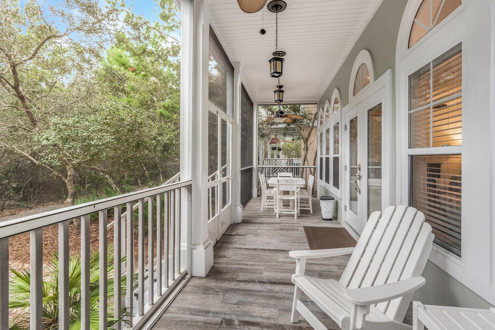 55 The Greenway Loop Panama City Beach, FL 32461 - Photo 8 of 32 a view of a porch with chairs and backyard