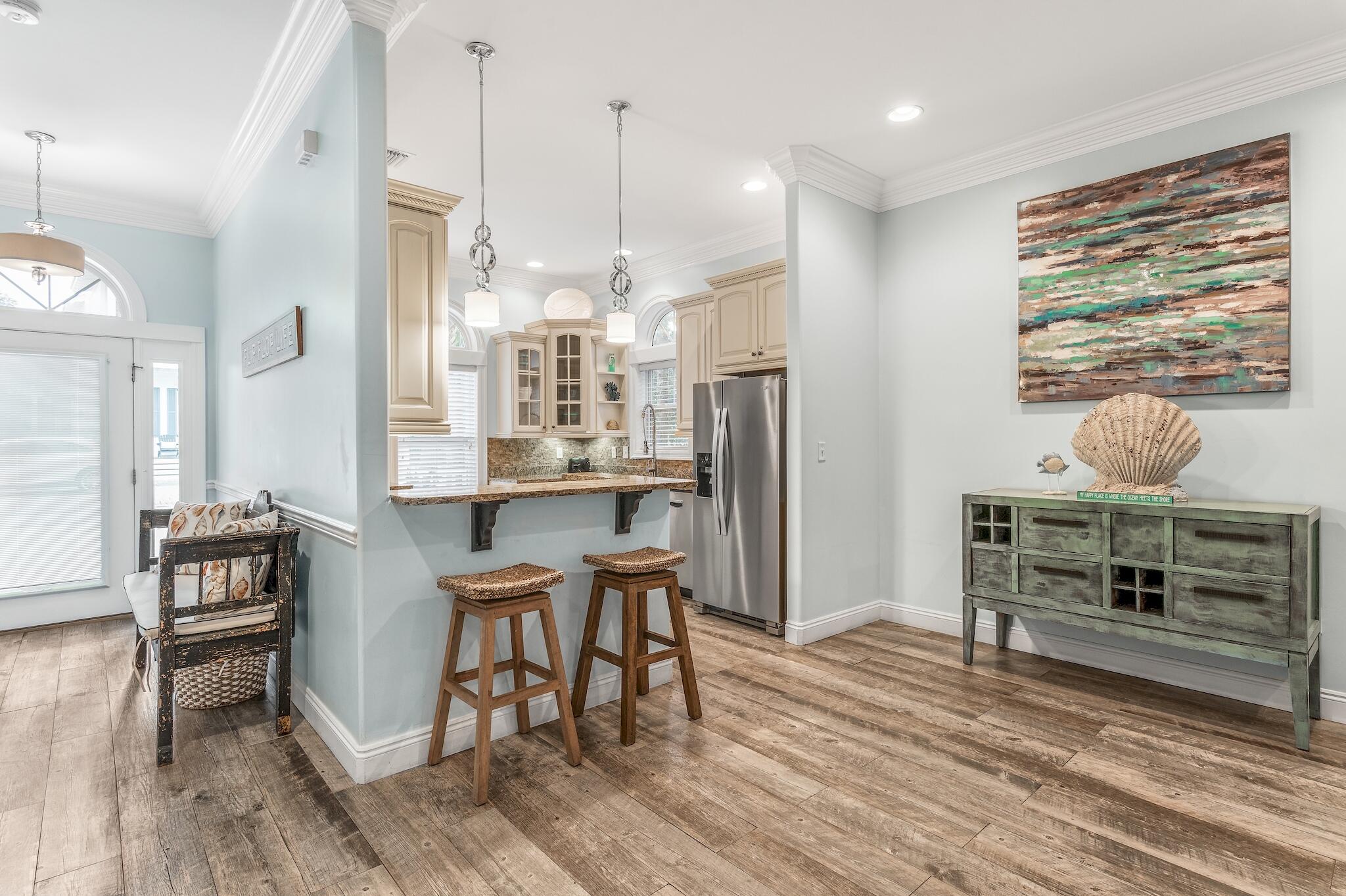 55 The Greenway Loop Panama City Beach, FL 32461 - Photo 10 of 32 a dining room with furniture and wooden floor