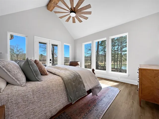 a bedroom with a large bed and a large window