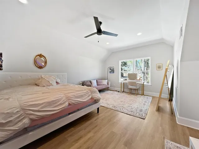 a bedroom with a bed and a large window