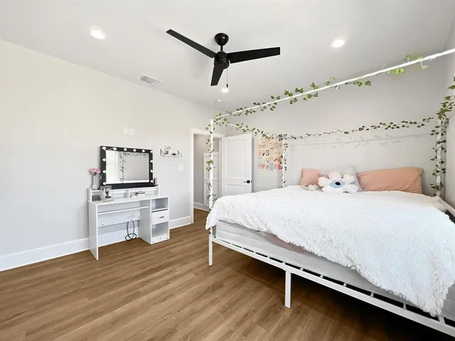 a bedroom with a bed and a ceiling fan
