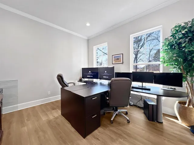 a view of a workspace with furniture and a window