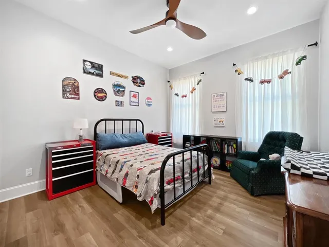 a bedroom with a bed couch and a window