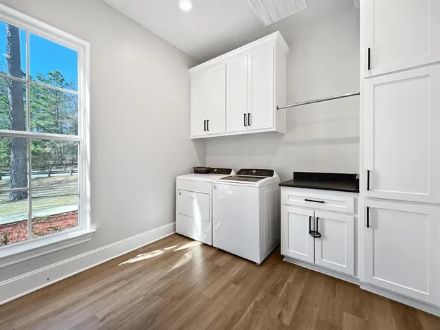 a kitchen with white cabinets and white appliances