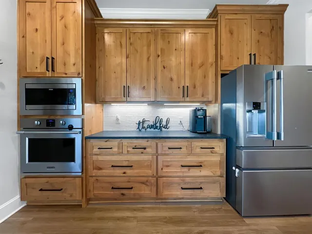 a kitchen with granite countertop a refrigerator and a stove