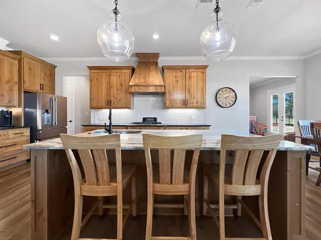 a large kitchen with a dining table and chairs
