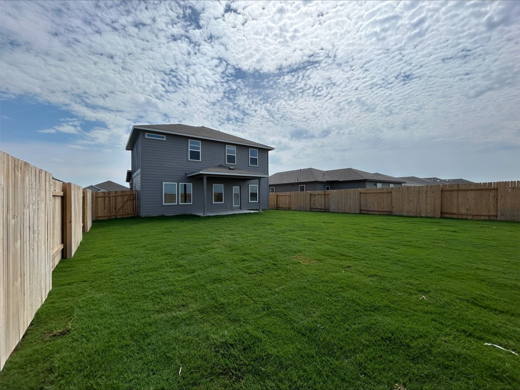 129 Honey Bee Road Jarrell, TX 76537 - Photo 5 of 10 a view of a wooden house with a big yard and large trees