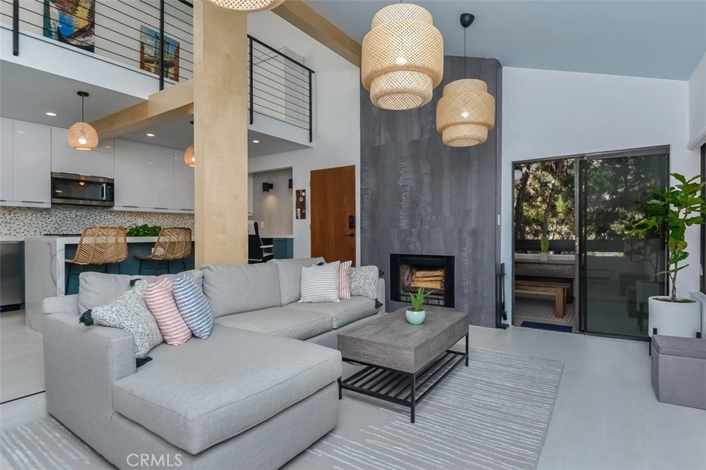 13708 Ruette Le Parc, Unit E Del Mar, CA 92014 - Photo 1 of 30 a living room with furniture kitchen view and a fireplace