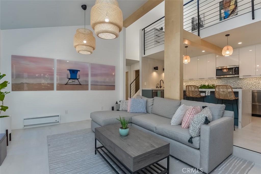 13708 Ruette Le Parc, Unit E Del Mar, CA 92014 - Photo 11 of 30 a living room with furniture kitchen view and a chandelier