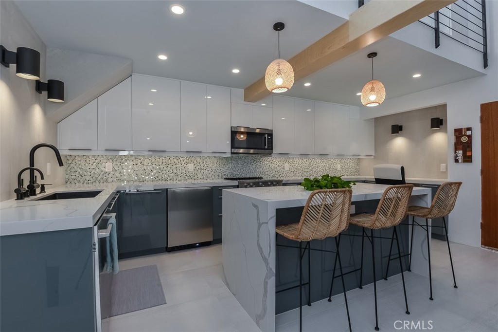 13708 Ruette Le Parc, Unit E Del Mar, CA 92014 - Photo 13 of 30 a kitchen with a sink cabinets and window