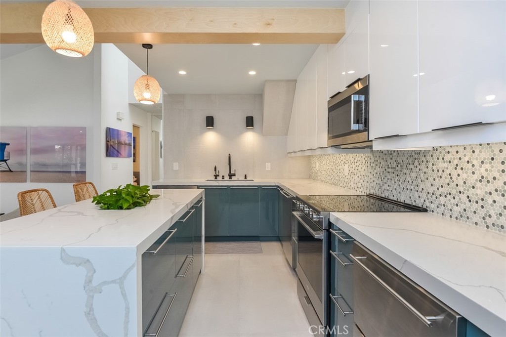 13708 Ruette Le Parc, Unit E Del Mar, CA 92014 - Photo 14 of 30 a kitchen with a sink a stove and cabinets