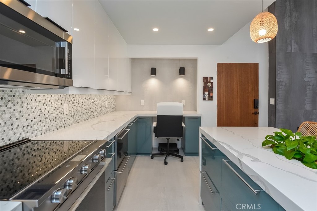 13708 Ruette Le Parc, Unit E Del Mar, CA 92014 - Photo 15 of 30 a kitchen with a sink appliances and cabinets
