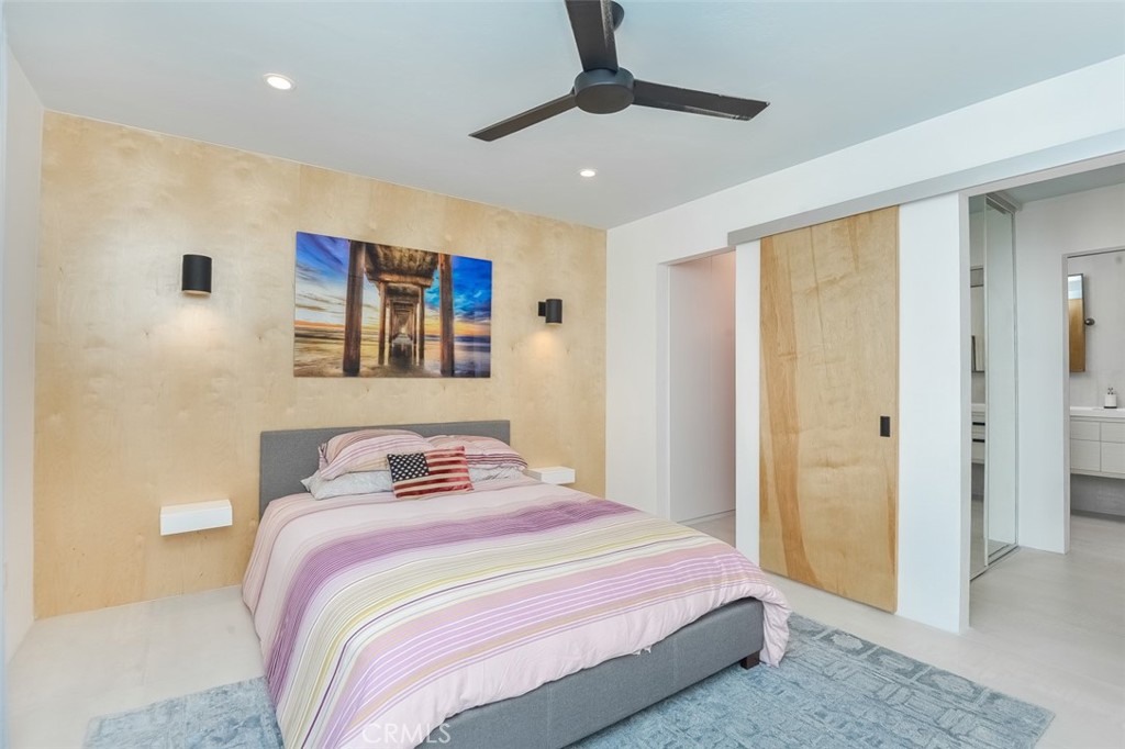 13708 Ruette Le Parc, Unit E Del Mar, CA 92014 - Photo 16 of 30 a bedroom with a bed and a view of bathroom