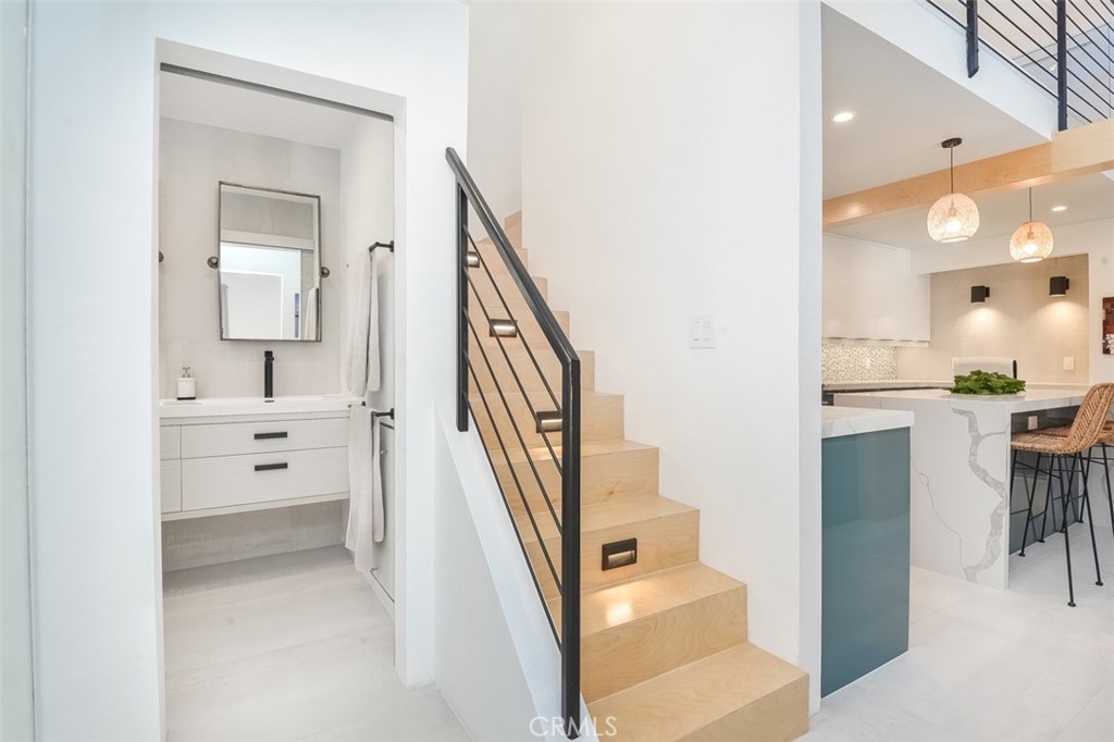 13708 Ruette Le Parc, Unit E Del Mar, CA 92014 - Photo 18 of 30 a bathroom with a sink a mirror and a