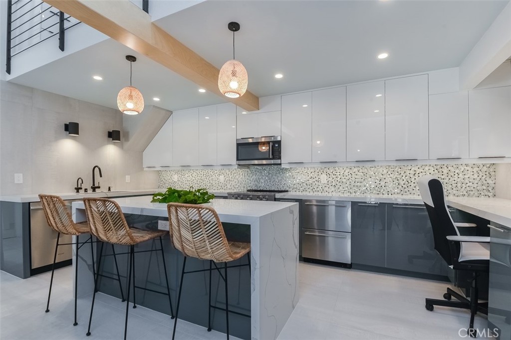 13708 Ruette Le Parc, Unit E Del Mar, CA 92014 - Photo 2 of 30 a kitchen with a dining table chairs and white cabinets