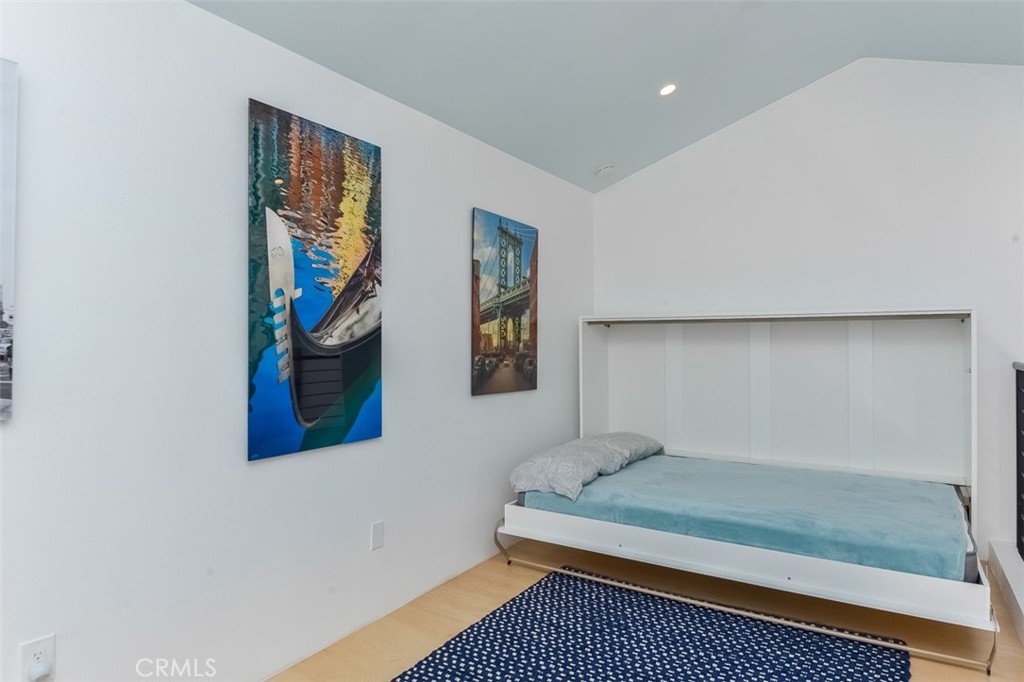 13708 Ruette Le Parc, Unit E Del Mar, CA 92014 - Photo 22 of 30 a bedroom with a bed and painting on the wall