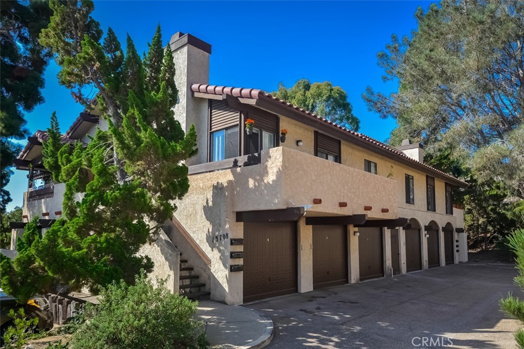 13708 Ruette Le Parc, Unit E Del Mar, CA 92014 - Photo 29 of 30 a front view of a house with plants