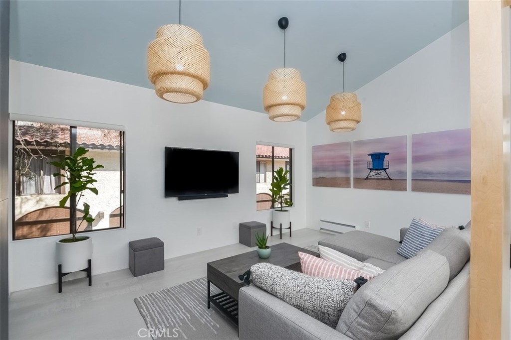 13708 Ruette Le Parc, Unit E Del Mar, CA 92014 - Photo 8 of 30 a living room with furniture kitchen view and a flat screen tv