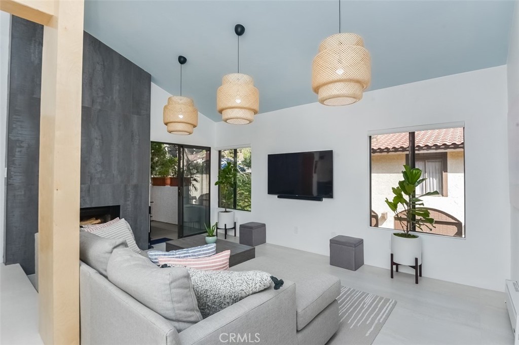 13708 Ruette Le Parc, Unit E Del Mar, CA 92014 - Photo 9 of 30 a living room with furniture a flat screen tv and a large window
