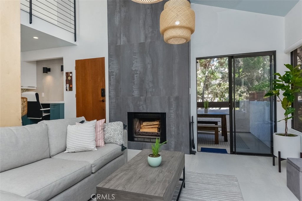 13708 Ruette Le Parc, Unit E Del Mar, CA 92014 - Photo 10 of 30 a living room with fireplace furniture and a window