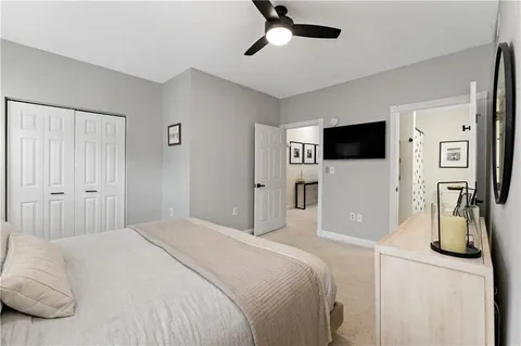 a bedroom with a bed a mirror and a window