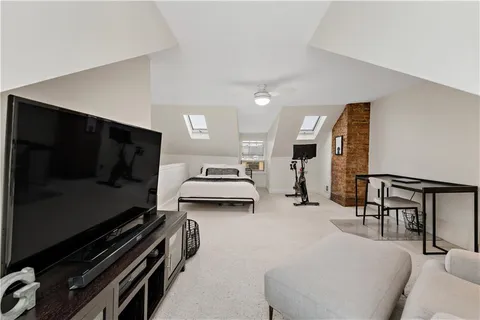 a bedroom with furniture and a window