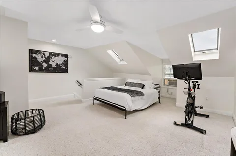 a bedroom with furniture and a flat screen tv