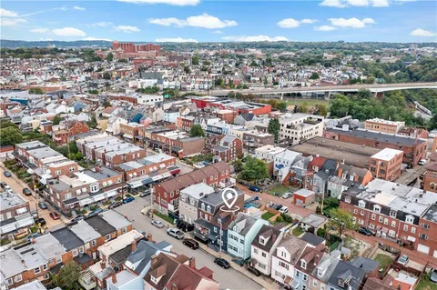 an aerial view of residential houses with outdoor space