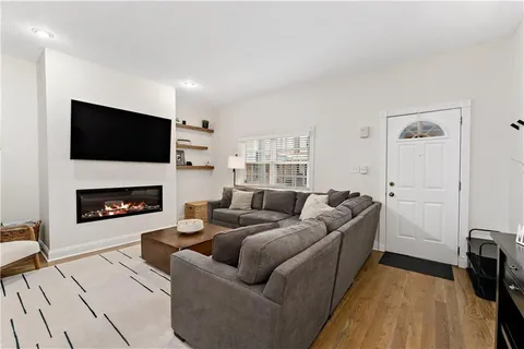 a living room with furniture and wooden floor