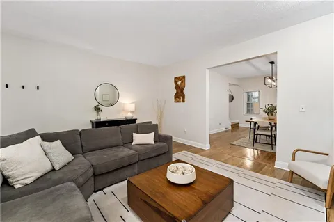 a view of a room with furniture and wooden floor