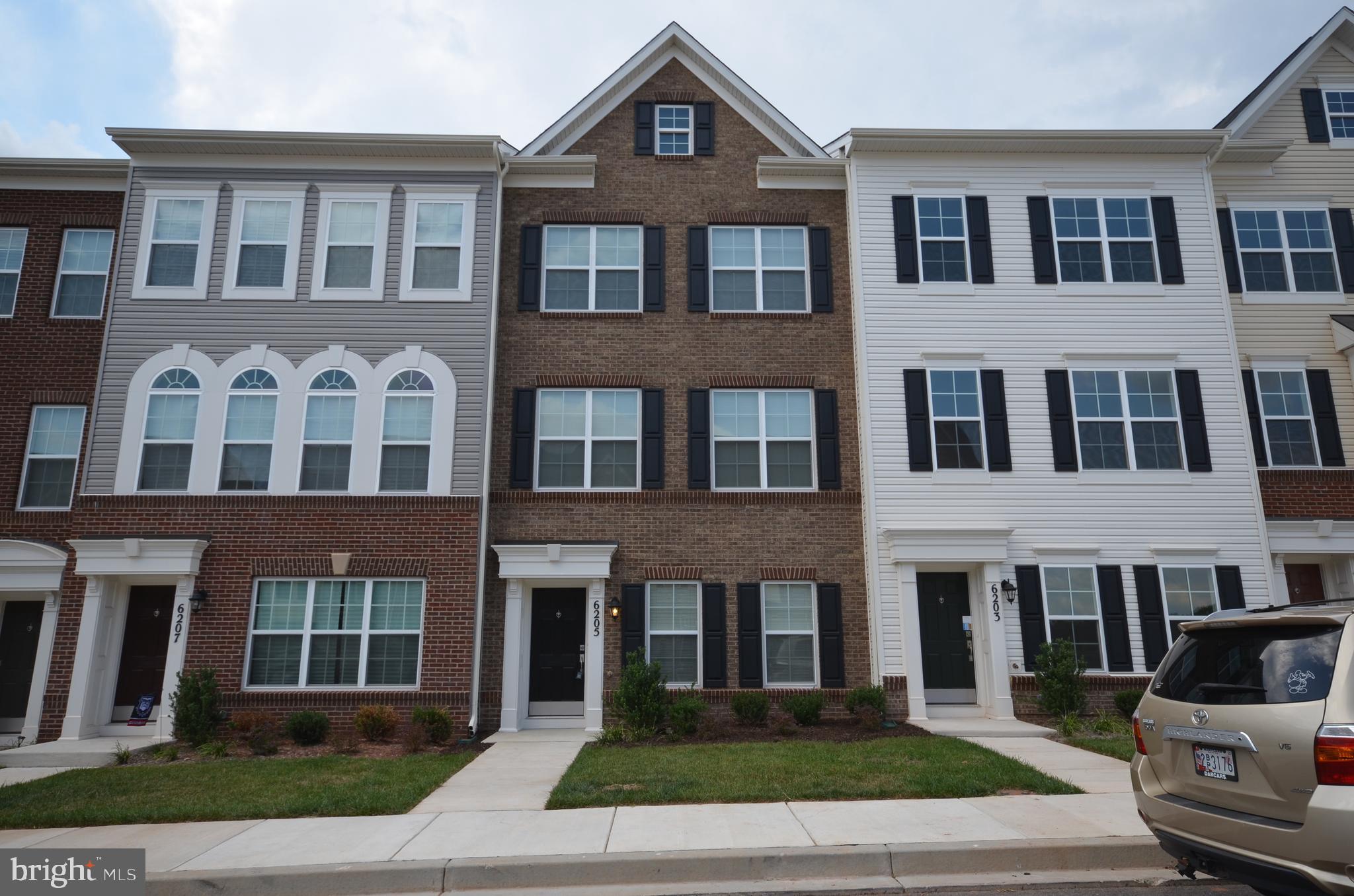 a front view of a residential apartment building with a yard
