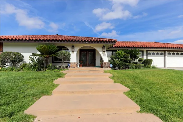 a front view of a house with a garden and deck