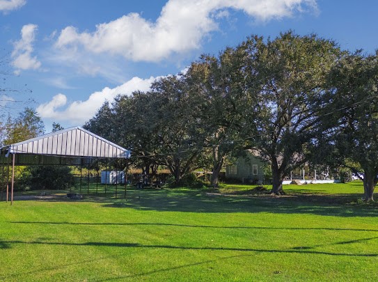 14721 North Fm 1663 Winnie, TX 77665 - Photo 1 of 6 a front view of a house with a yard
