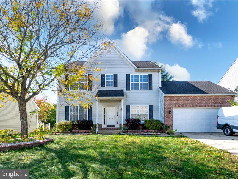 128 West Sheldrake Circle Dover, DE 19904 - Photo 1 of 40 a front view of a house with a yard and garage