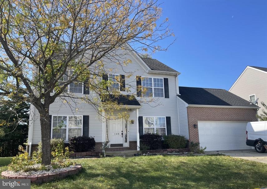 128 West Sheldrake Circle Dover, DE 19904 - Photo 2 of 40 a front view of a house with a yard and garage