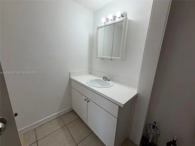a bathroom with a sink vanity and a mirror