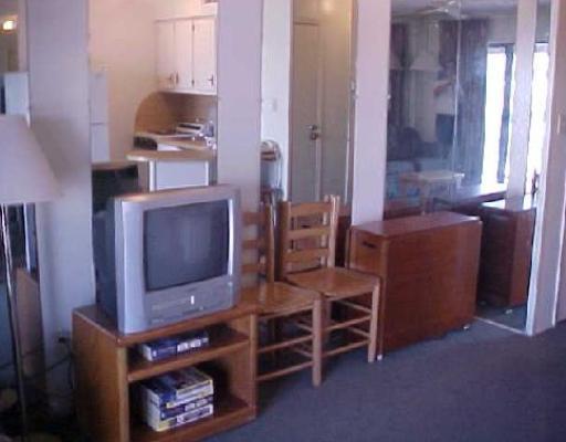 3938 Surfside, Unit 1335 Corpus Christi, TX 78402 - Photo 3 of 6 a living room with furniture a flat screen tv and kitchen view