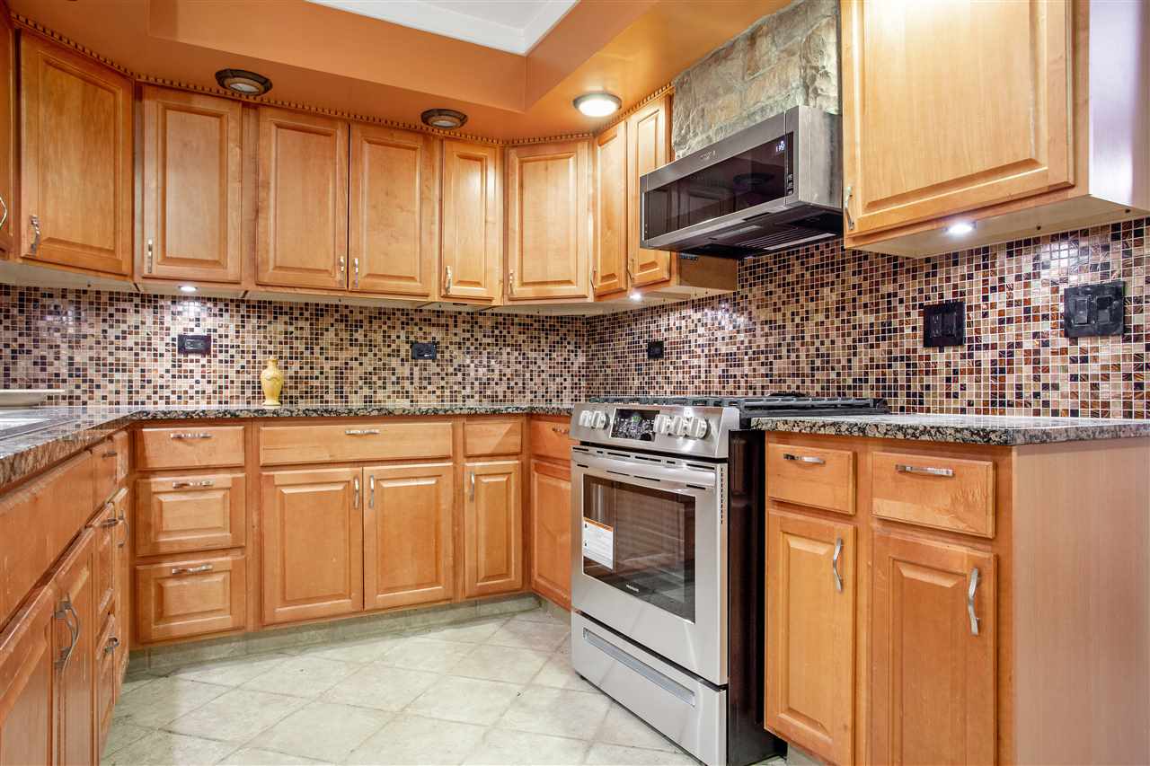 5115 Brookview Road Rockford, IL 61107 - Photo 6 of 21 a kitchen with stainless steel appliances granite countertop a sink stove and cabinets