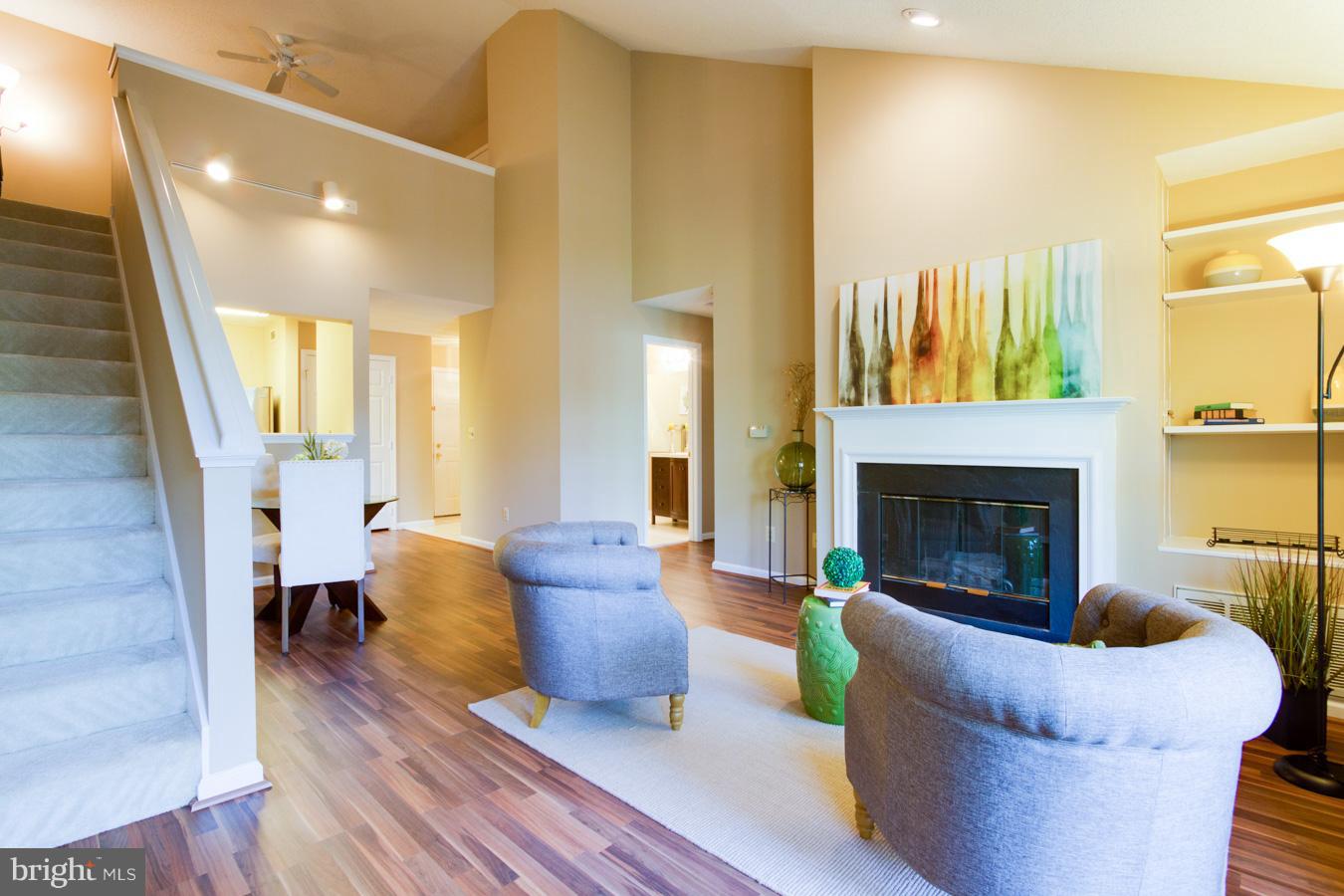 12016 Taliesin Place, Unit 34 Reston, VA 20190 - Photo 1 of 30 a living room with furniture and a fireplace