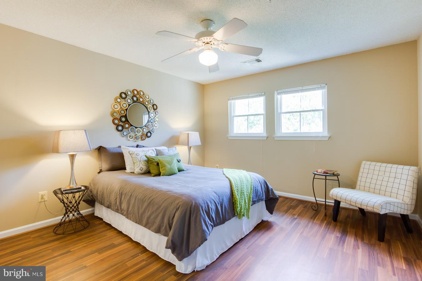 12016 Taliesin Place, Unit 34 Reston, VA 20190 - Photo 12 of 30 a bedroom with a bed and wooden floor