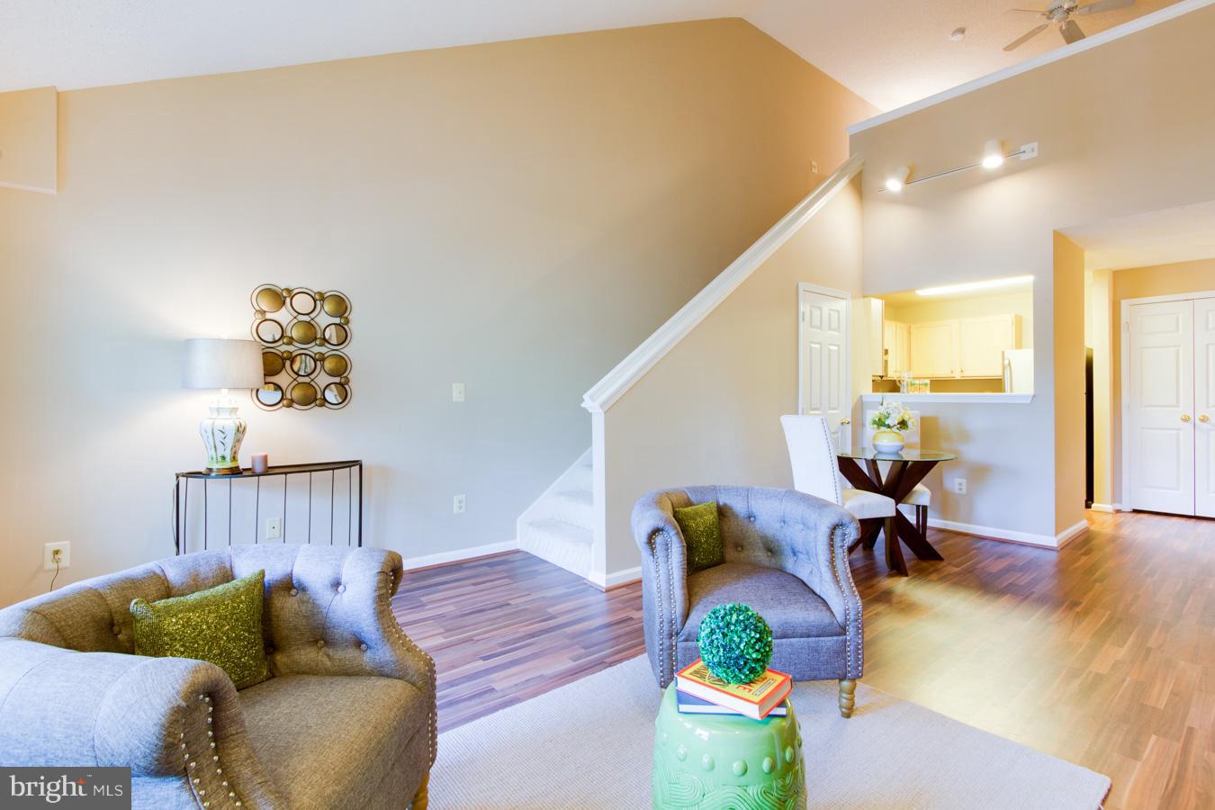 12016 Taliesin Place, Unit 34 Reston, VA 20190 - Photo 17 of 30 a living room with furniture and wooden floor