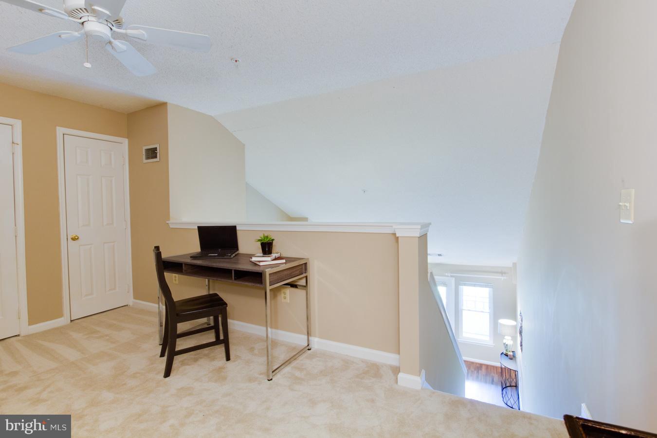 12016 Taliesin Place, Unit 34 Reston, VA 20190 - Photo 19 of 30 a view of a workspace with furniture and a chandelier fan