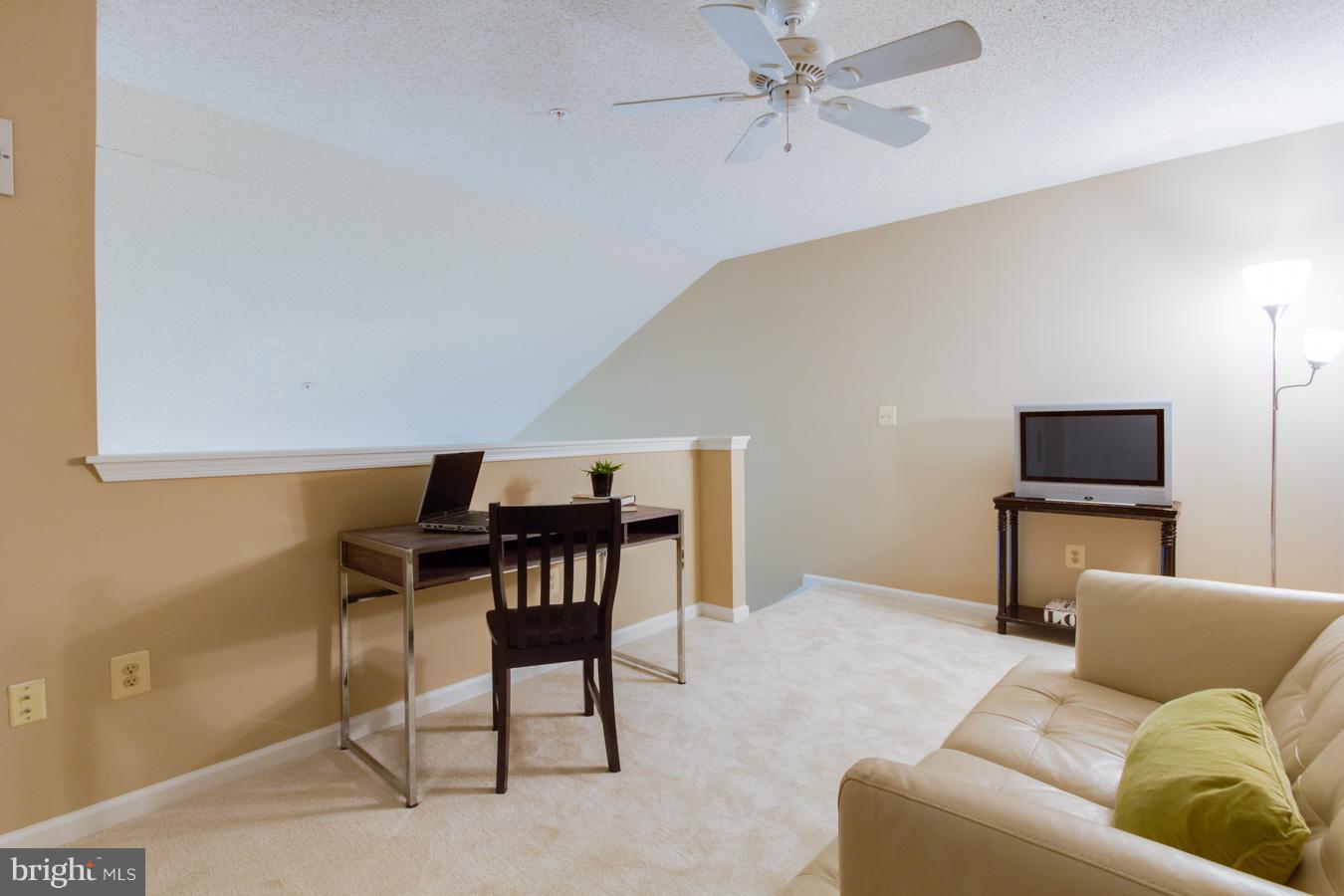 12016 Taliesin Place, Unit 34 Reston, VA 20190 - Photo 20 of 30 a living room with furniture and a flat screen tv