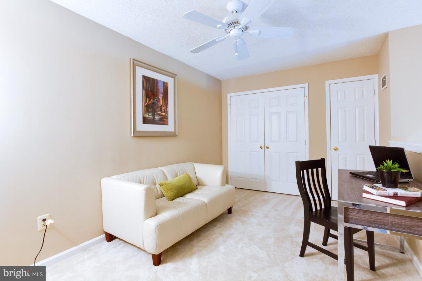 12016 Taliesin Place, Unit 34 Reston, VA 20190 - Photo 21 of 30 a living room with furniture and a flat screen tv